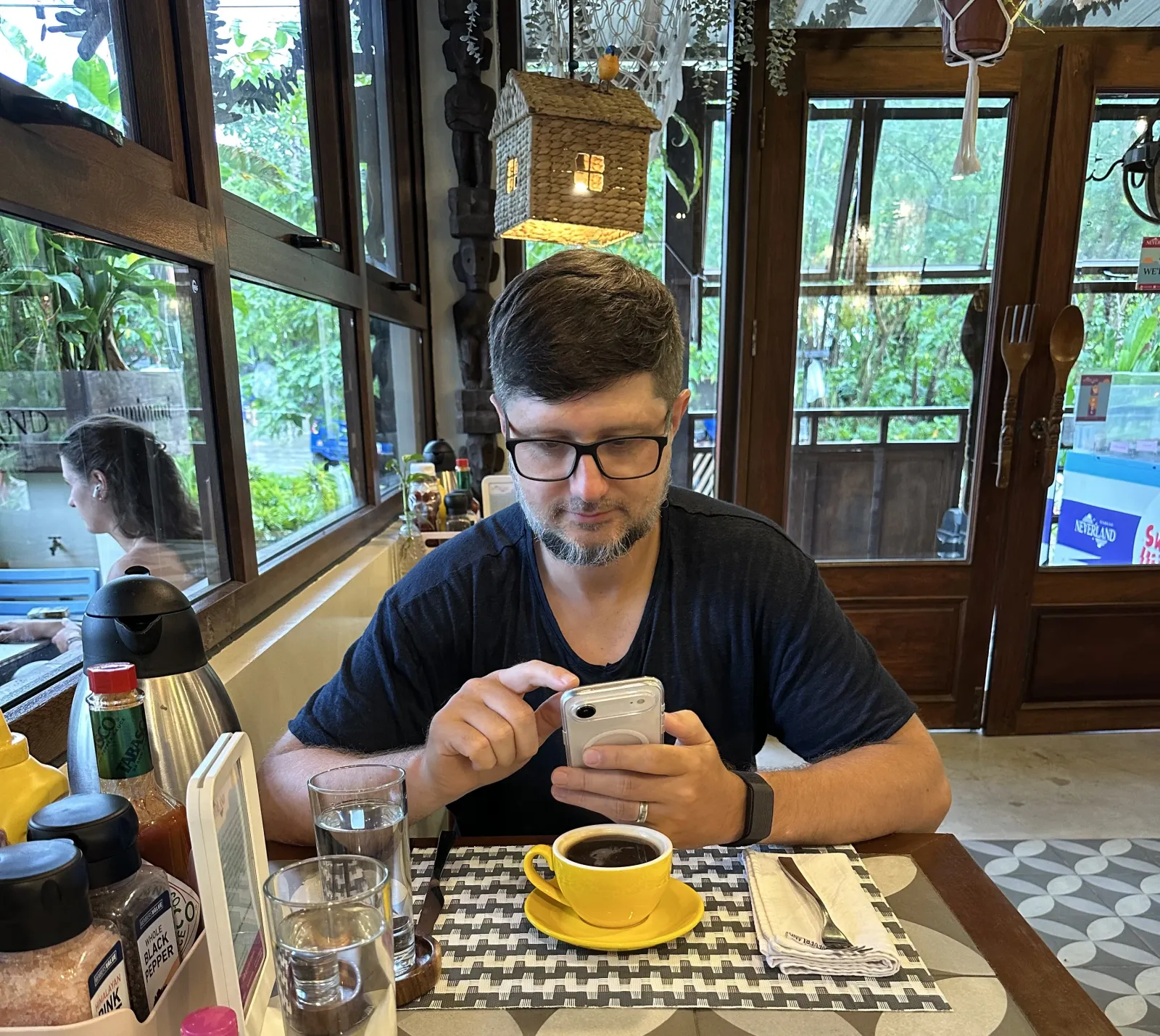 Artem on his phone at a cafe in Asia, talking to Kent